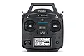 A black Futaba T6K 8-channel RC transmitter with a digital display screen, control sticks, and switches, viewed from the front against a white background.