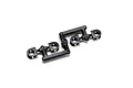 A set of four black plastic shock cap bushings for Kyosho RC cars, still attached to their original molding tree.