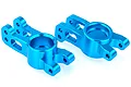 Two bright blue anodized aluminium rear hub carriers for an RC car, shown from an angled perspective on a white background.
