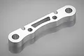A silver-coloured metal HSP front lower suspension arm mount for an RC car, shown from a high-angle studio perspective.
