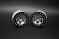 Two Reefs RC 1.9-inch Granite beadlock rims in silver and black finish, shown from a front-facing angle against a dark background.