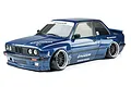 A dark blue MST RMX 2.5 E30RB RC drift car with a wide-body Pandem kit, featuring black multi-spoke wheels and white decals on a white background.