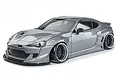 A metallic grey MST RMX 2.5 86RB RC drift car on a white background, featuring a wide-body kit and black wheels.