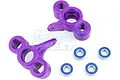 Two purple RPM steering hubs for an RC vehicle alongside four small metal ball bearings on a white background.
