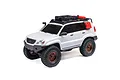 Axial SCX24 Lexus GX 470 RC rock crawler in white with off-road accessories, roof rack, and bronze wheels on a white background.