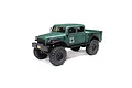 Axial SCX24 Dodge Power Wagon RC rock crawler in green, featuring a detailed truck body, large off-road tires, and black wheels on a white background.