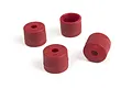 Four small, cylindrical red plastic wheel washers or spacers arranged on a white background.