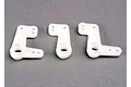 Three white plastic bell crank steering components for a Traxxas RC vehicle arranged on a grey surface.