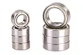 Two stacks of metal ball bearings of different sizes, showing a total of eight bearings arranged against a white background.