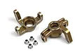 Two gold-anodized aluminium steering hub carriers for an RC car, accompanied by four small silver metal bushings.