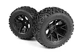 Two black RC monster truck wheels with Linebacker tread pattern on black rims, studio shot on white background.