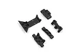 A set of four black plastic RC suspension mount parts arranged on a white background.