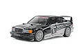 A studio shot of a Tamiya 1/10 scale RC Mercedes-Benz 190 E 2.5-16 EVO II touring car model with black and white racing livery on a white background.