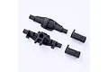 FMS RC rear axle housing components in black plastic, including the main housing halves and two end caps, isolated on a white background.