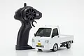 A white Kyosho First Mini-Z Subaru Sambar RC truck with its black pistol-grip remote controller on a white background.