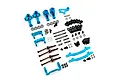 A collection of blue anodized aluminium RC car suspension and steering upgrade parts, including hubs, driveshafts, and linkages on a white background.