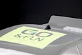 A small black shark fin style roof antenna mounted on a clear polycarbonate RC car body shell with a GO & FUN sticker.