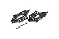 Two black plastic RC helicopter main frame halves and a set of small black screws arranged on a white background.