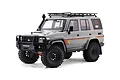 RGT Rescuer LC76 1/10 scale RC rock crawler in grey with black off-road accessories, including a roof rack, snorkel, and bull bar.