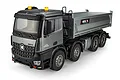 A studio shot of a grey Huina 1536-Pro RC dump truck on a white background, showing the cab, dump bed, and wheels.