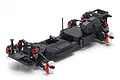 A studio shot of the Kyosho Fazer D2 RC drift car chassis, featuring a black plastic frame with red anodized aluminum suspension components.