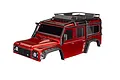 A red Traxxas TRX-4 Land Rover Defender RC body shell with a black roof rack and fender flares, shown against a white background.