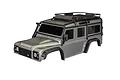 A silver Traxxas TRX-4 Land Rover Defender RC body shell with a black roof rack and fender flares against a white background.