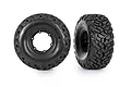 Two black Traxxas Pro Scale RC tyres with aggressive tread patterns, shown from front and side angles against a white background.