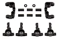 Team Associated RC steering hubs, C-hubs, and small plastic spacers arranged on a white background.