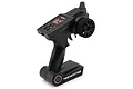 A black UDI RC 2.4GHz pistol-grip transmitter for RC vehicles, featuring a steering wheel, throttle trigger, and adjustment dials on a white background.