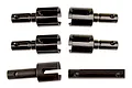 A set of five black metal RC differential outdrive components arranged on a white background.
