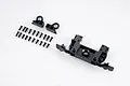 FMS RC body mount set including a main plastic mount, two small brackets, and a collection of black screws on a white background.