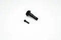 A black metal differential pinion gear and a small threaded grub screw on a white background.