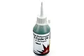 A 100ml bottle of Dynamite high-performance 2-cycle oil for gas engines, featuring a white cap and a green liquid contents.