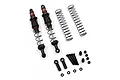 A pair of Yeah Racing 110mm Desert Cobra dual spring RC shock absorbers in black and red, with spare springs and mounting hardware on a white background.