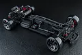 Top-down view of an assembled MST RMX 4 Classic 1/10 scale RWD RC drift car chassis on a black textured background.