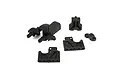 A set of black plastic RC car spare parts including a gear cover and various mounting components on a white background.