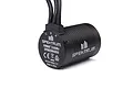 Spektrum Firma 3300Kv brushless motor with black finned casing and three wire leads, showing branding and model number on the end cap.