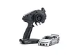 Kyosho Mini-Z Nissan Skyline GT-R NISMO R33 RC car in silver with its black Syncro KT-531P transmitter on a white background.