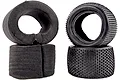 Two black RC buggy tyres with knobby tread patterns and two matching grey foam inserts against a white background.