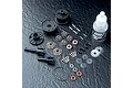 A complete MST V2 bevel differential kit laid out on a dark textured surface, including plastic housing parts, metal gears, pins, screws, and gear oil.