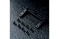 A black aluminium RC servo mount with mounting hardware including screws and washers on a dark textured surface.