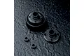 MST wide version bevel gearbox case components including a gear housing, a cover plate, and two small bushings on a dark textured surface.