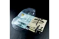 Clear, unpainted MST S15RB RC car body shell with included black plastic parts and decal sheet on a dark textured background.