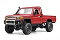 Studio shot of the MN Model Toyota LC79 1/12 scale RC rock crawler in red against a white background.