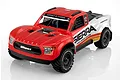 UDI RC Mini Sierra 1/12 scale 4x4 electric short course truck in red and white with sponsor decals against a white background.