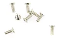 A group of seven small silver-coloured metal countersunk screws scattered on a white background.