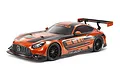 Studio product photo of Tamiya TT-02 Mercedes-AMG GT3 EVO RC car in orange and black livery on white background.