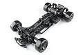 Top-down studio shot of the MST RMX 4 GT competition-level RC drift car chassis kit in black with carbon fiber components.