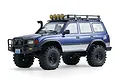 Studio shot of the FMS FCX10 Pro Toyota Land Cruiser LC80 RC rock crawler in blue, featuring a roof rack and bull bar.